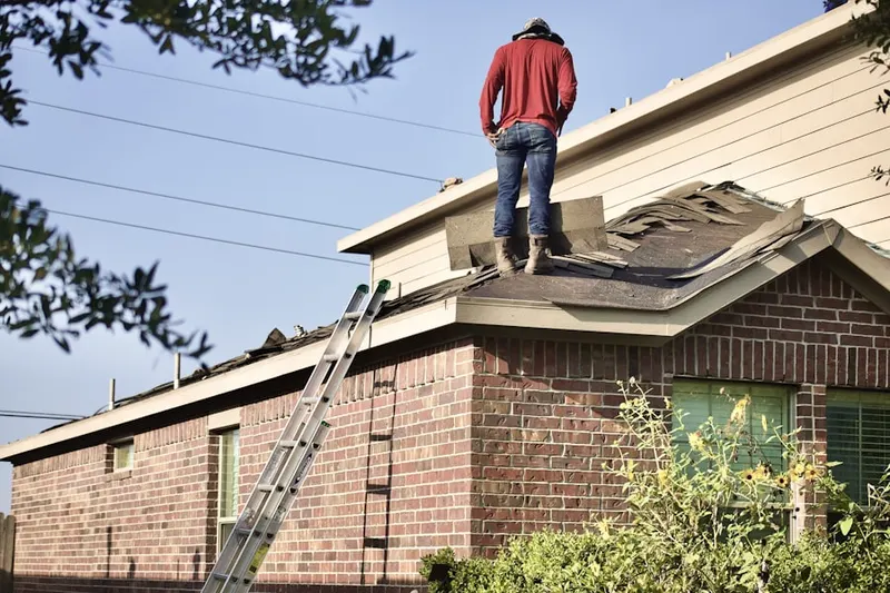 Professional roofer working on a residential roof in Yaphank